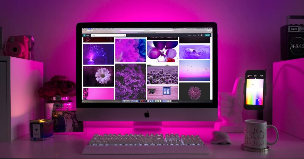 pexels-photo-1779487-1779487 Modern desk setup with neon lighting and a desktop computer displaying colorful images.